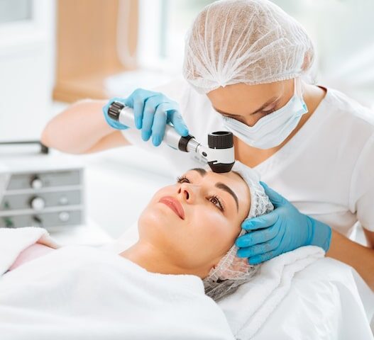 “Dermatologist examining patient and recommending medical grade skincare treatments”