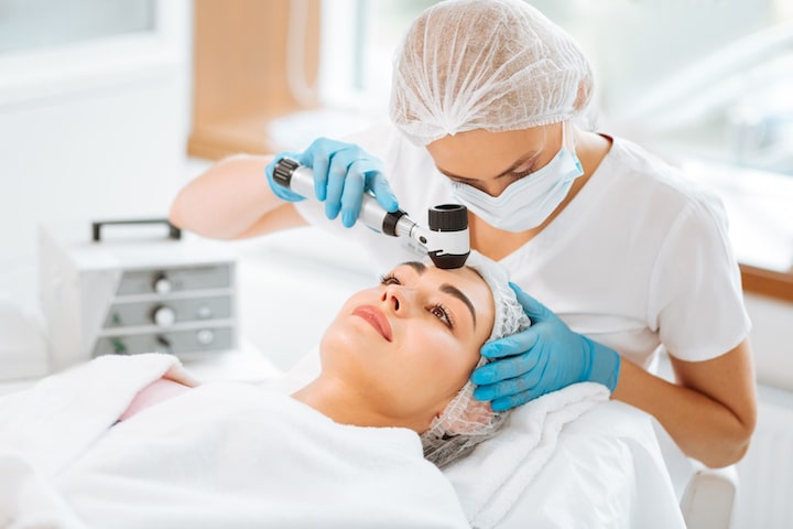 “Dermatologist examining patient and recommending medical grade skincare treatments”