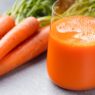 Fresh glass of carrot juice with carrots – benefits of carrots juice for health and energy