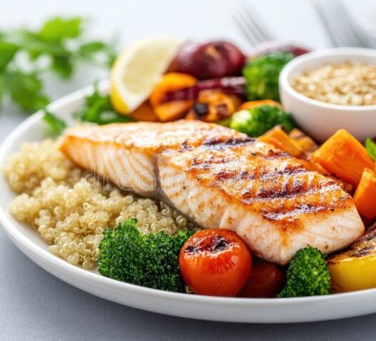 Healthy pescatarian meal with salmon, vegetables, and quinoa.