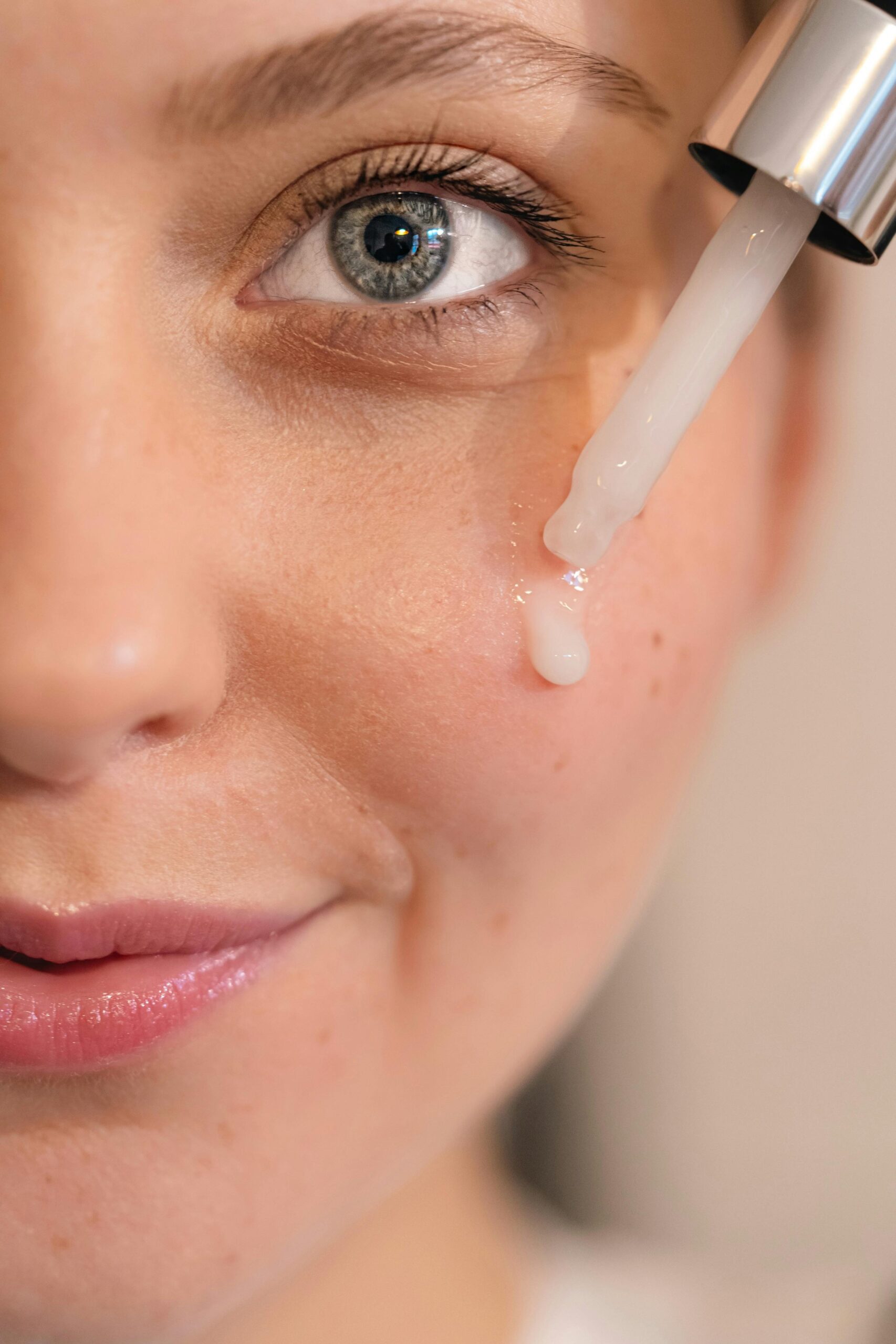 applying a white moisturizer or serum drop
